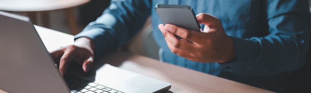 Man using laptop and phone